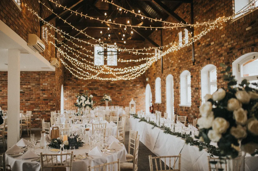 Wedding Breakfast in brick lined hall and twinkling lights