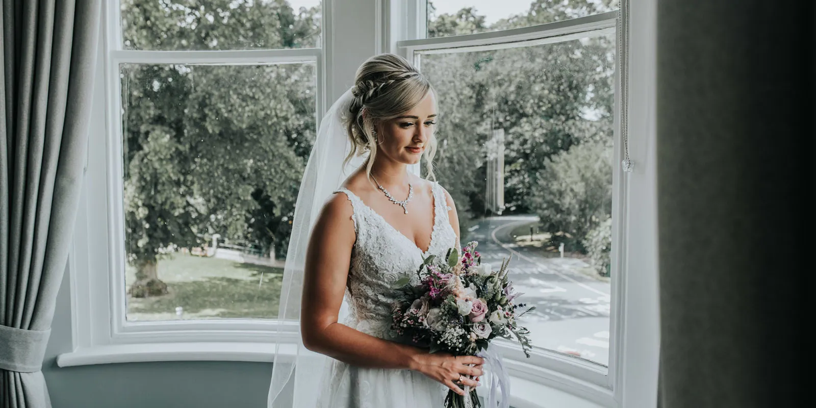 Bride in window with bouquet
